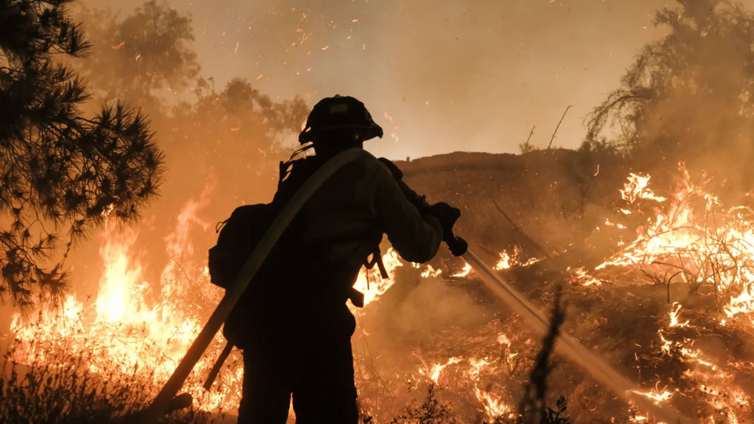 A Firefighter Battles A Fire In California