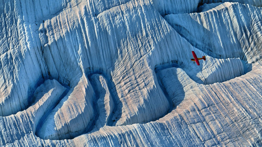 Nat Geo Red Plane Over Ice Gorge
