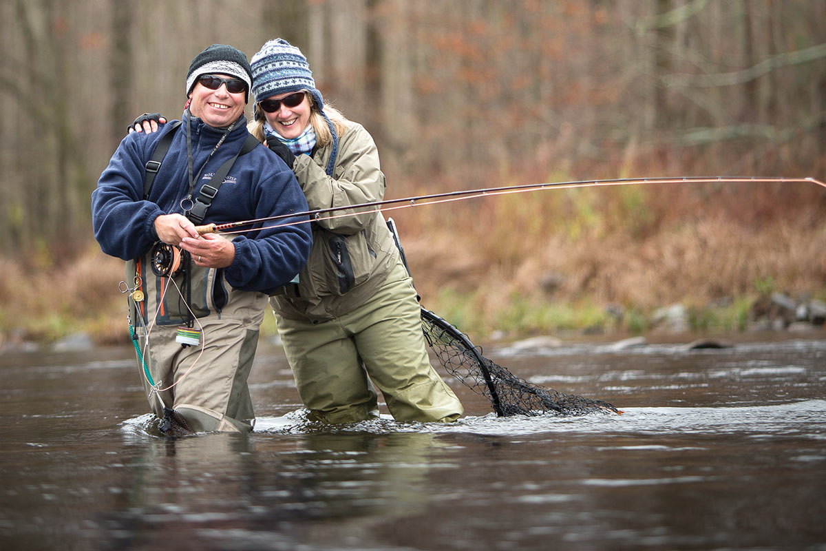 couple fly fishing in the fall