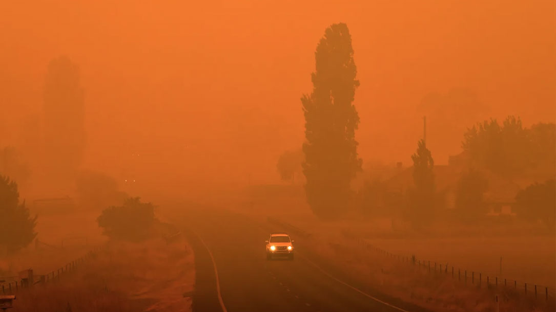 Residents commute on a road through thick smoke from bushfires in Bemboka in Australias New South Wales state on Jan 5 2020